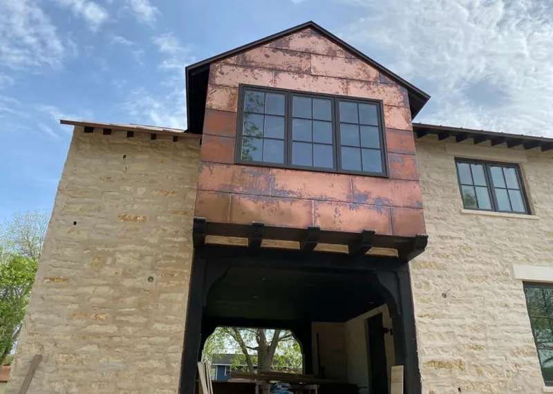 Copper metal panel facade on a stone building for Skylight Installation in Sierra Madre